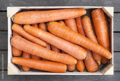 Wooden box of fresh carrots