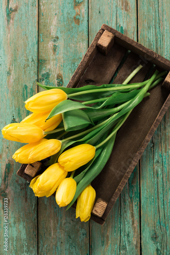 beautiful yellow tulips on wooden background  father  mother  women  valentine s day concept