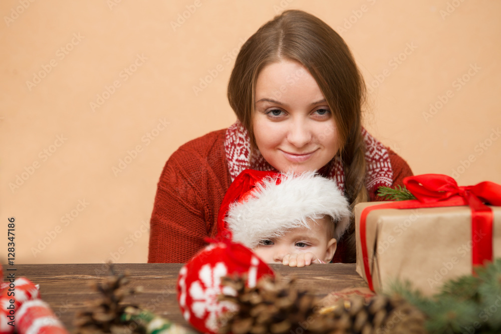 Mother and baby daughter making preparations for Christmas
Mother and baby daughter making preparations for Christmas