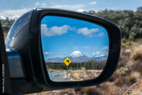 Road to Tongariro National Park with Kiwi sign reflected in the rear mirror, New Zealand