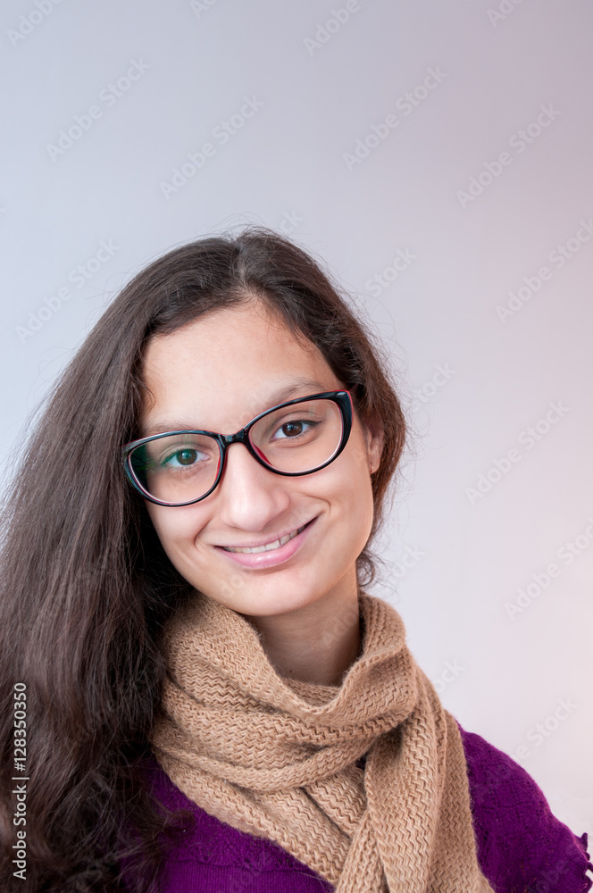 Beautiful girl with a scarf in glasses smiling