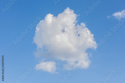 Cumulus clouds over the blue sky background.