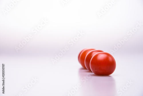 Fresh cherry tomatoes line isolated on white background cutout