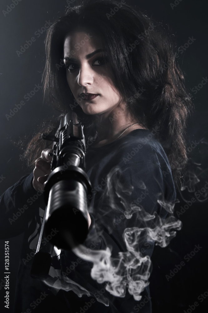 Young woman holding an assault rifle Young woman holding an assault rifle