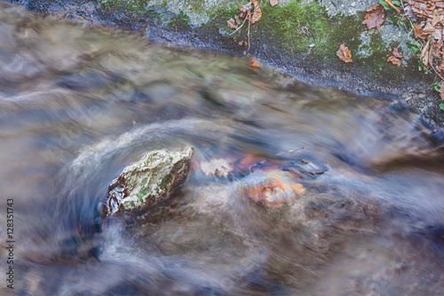 Rock in the middle of a stream photo