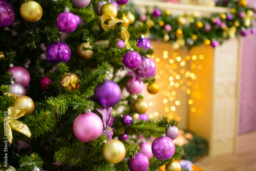Christmas tree decorated in purple toy. background with gifts