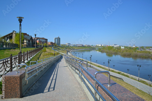 Spring high water of the Tura River on the embankment in Tyumen,