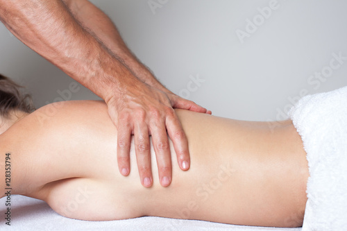 back massage of a woman with white towel