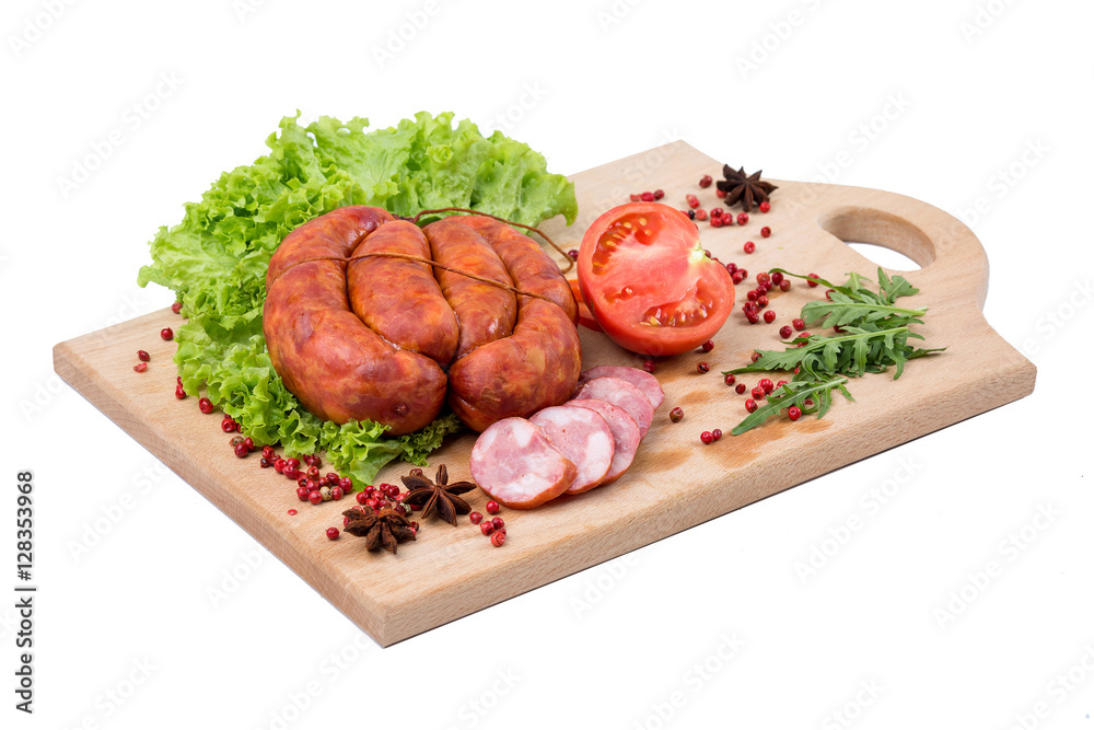 Smoked sausages on a kitchen wooden board on white background