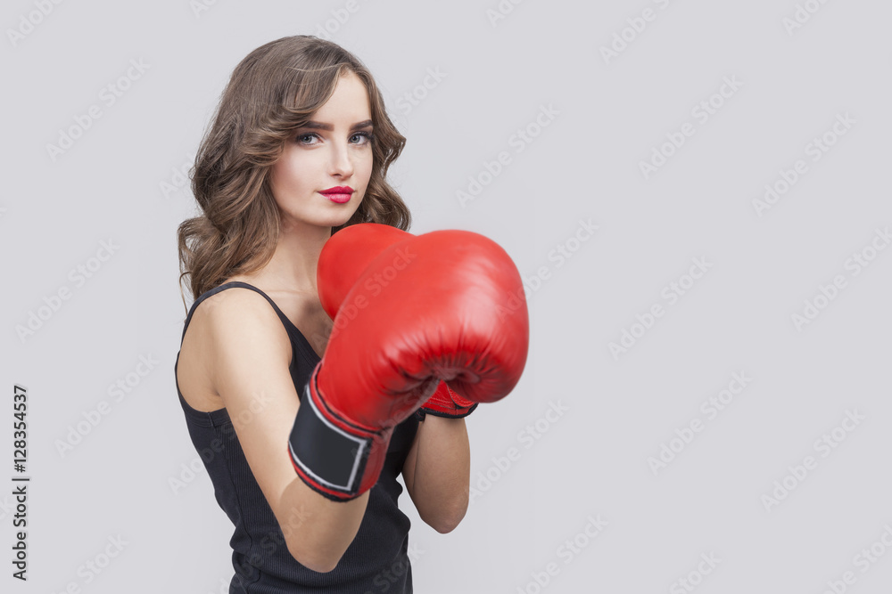 Pretty girl with long wavy hair and boxing gloves Pretty girl with long wavy hair and boxing gloves