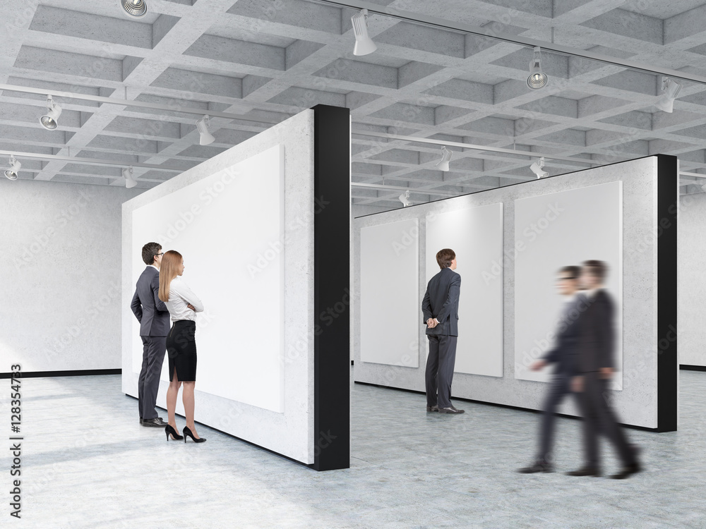 Fototapeta premium People looking at pictures in art gallery with interesting ceili