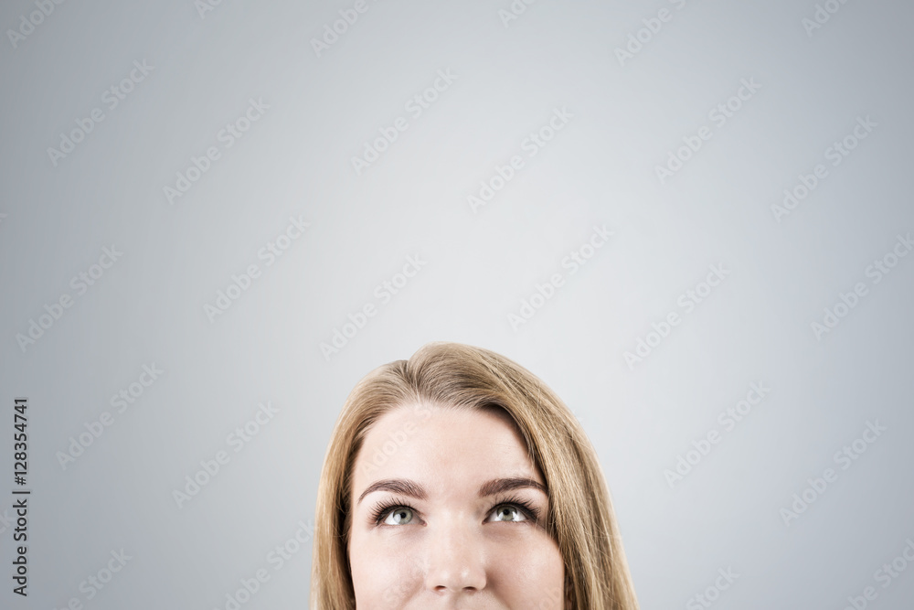 Close up of woman's head with long hair near a gray wall Close up of woman's head with long hair near a gray wall