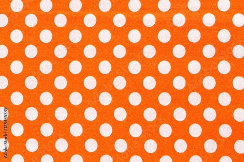 Orange and white distressed polka dots background.