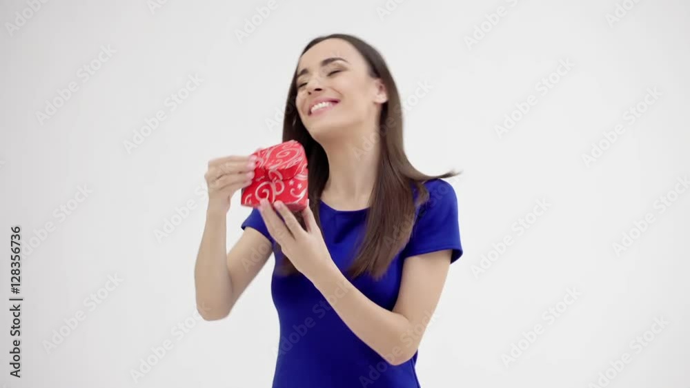 Beautiful woman holding heart shaped gift Beautiful woman holding heart shaped gift