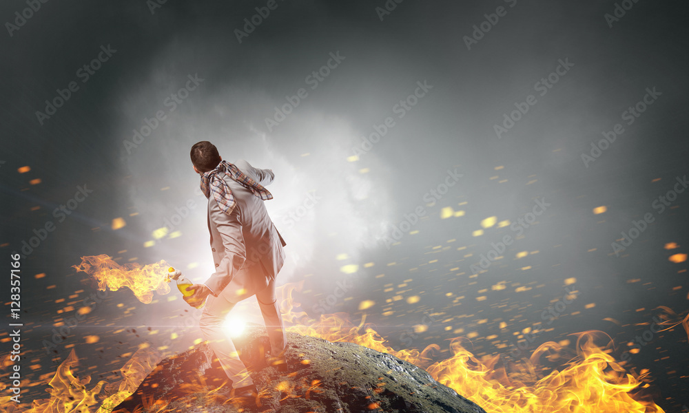 Naklejka premium Businessman throwing petrol bomb . Mixed media