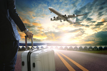 business man and traveling luggage standing in airport terminal