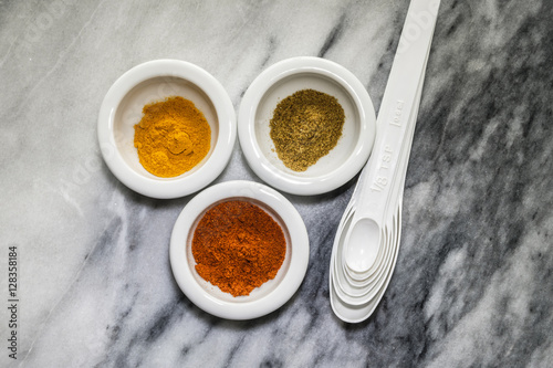 Spices and spoons on marble