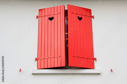 Red, wooden shutters with a heart