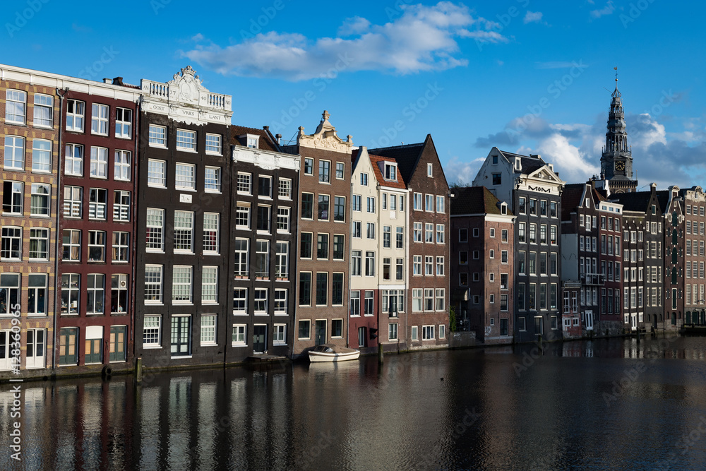 Coverted warehouses and the spire of St Nicholas church, Amsterdam, Netherlands