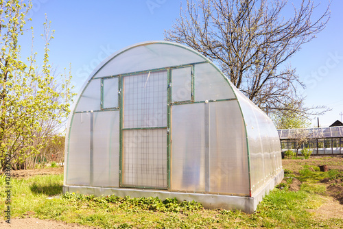 Modern Polycarbonate Greenhouse in Allotments for Growing Vegetables, Glasshouse Made of Polycarbonate, Farmland with Glasshouse, Plant Nursery, Sunlight Semicircle Hothouse, Self-sustaining © Supertrooper