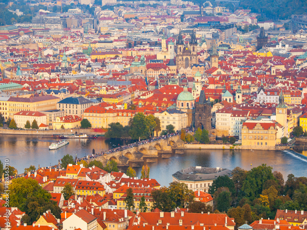 Naklejka premium Aerial view of cityscape with Charles Bridge over Vltava River and Old Town of Prague from Petrin Hill Observation Tower in the sunny evening, Prague capital city of Czech Republic, Europe. UNESCO