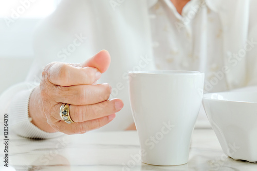 Close up image of senior women with drink, meal time 