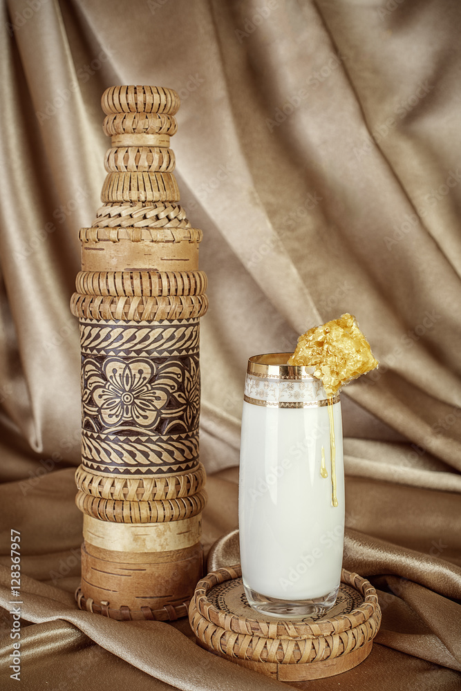 organic milk in handmade wooden bottle and glass of milk with ho