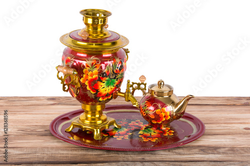 Traditional Russian samovar and a teapot on a tray on white background