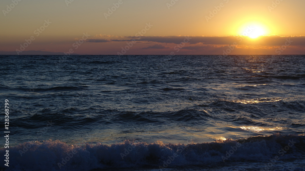 The sun rises over the waves