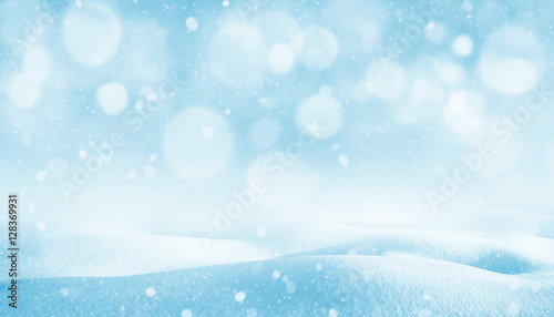 Winter background. Winter bright landscape with snowdrifts and falling snow. © Leonid Ikan