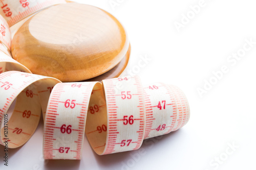 Yo-yo effect concept. Wooden yoyo with centimeter measure.