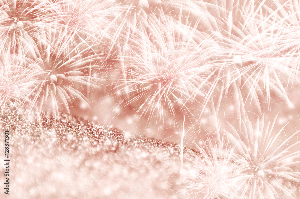 Silver and Rose gold fireworks and bokeh on gliter paper at New Year and copy space. Abstract background holiday. Silver and Rose gold fireworks and bokeh on gliter paper at New Year and copy space. Abstract background holiday.