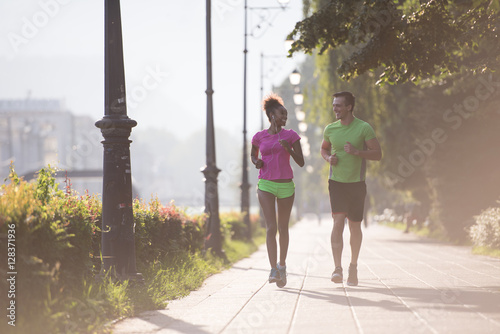 young multiethnic couple jogging in the city