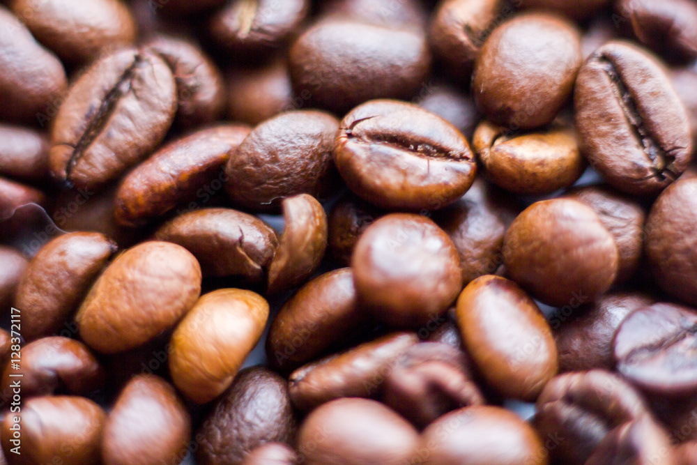 Close up beans on a white background. Coffee on the entire screen for the background. Roasted coffee beans brown. Lots of coffee in high definition. Close up beans on a white background. Coffee on the entire screen for the background. Roasted coffee beans brown. Lots of coffee in high definition.