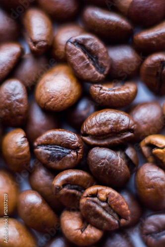 Close up beans on a white background. Coffee on the entire screen for the background. Roasted coffee beans brown. Lots of coffee in high definition.
