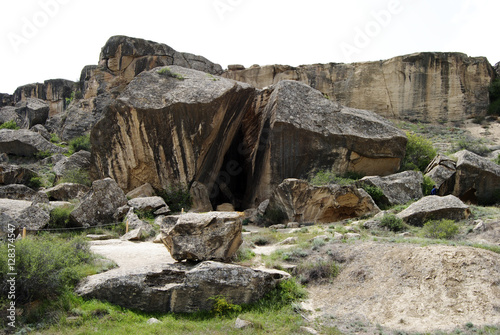 Landscape in Gobustan Rock Art Cultural Landscape Reserve in Azerbaijan  with rocks among grass.