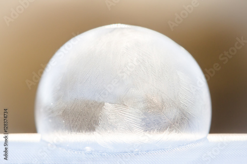 Abstract shot of an icy  frozen soap bubble dome on a flat surface