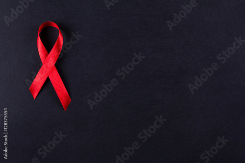 Red ribbon as symbol of aids awareness on white
