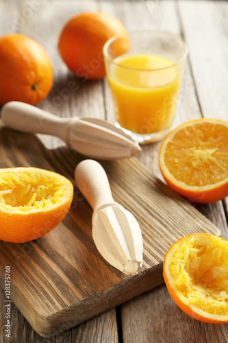 Citrus fruits with juicer on a grey wooden table