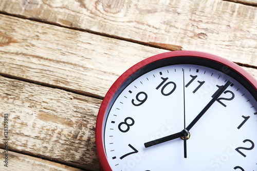 Wallpaper Mural Red round clock on a grey wooden table Torontodigital.ca