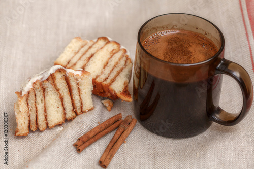 Freshly cinnabon French bun with cinnamon and coffee, selective focus photo