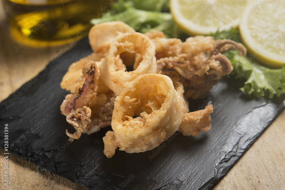 fried crispy calamari served on slate plate fried crispy calamari served on slate plate