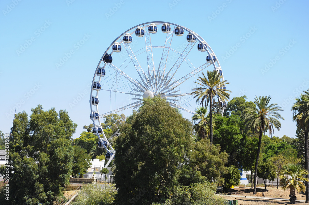 Fototapeta premium Large ferris wheel against blue sky