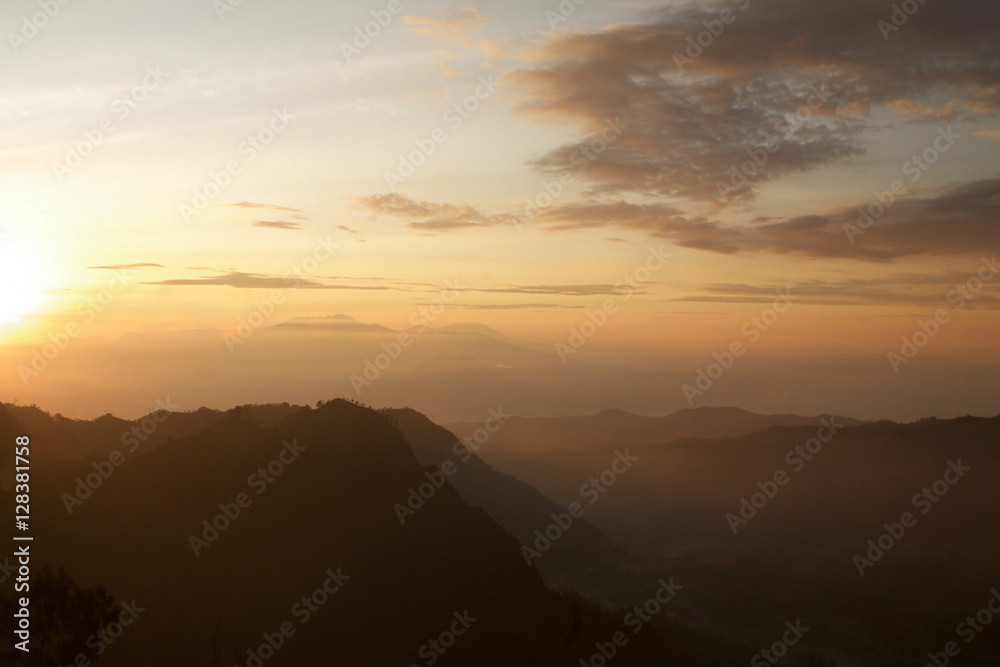 silhouettes of mauntains in the fog, sunrise at tengger national