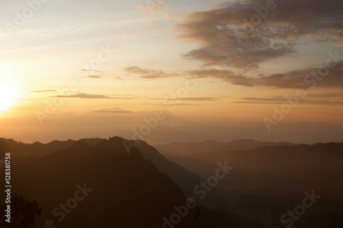 silhouettes of mauntains in the fog, sunrise at tengger national