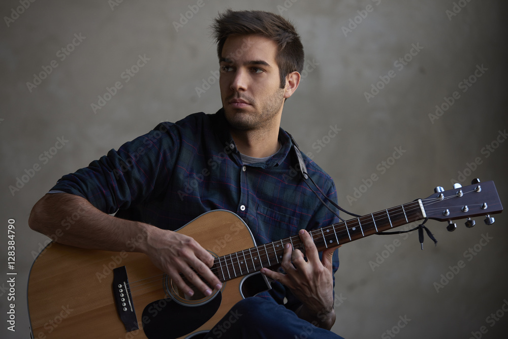 Obraz premium Playing on guitar. Shot of a young talent musician practicing on his electric guitar.