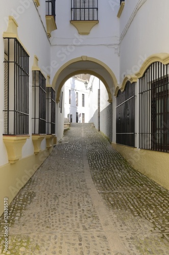 White alley with a touch of yellow  in Ronda, Spain photo