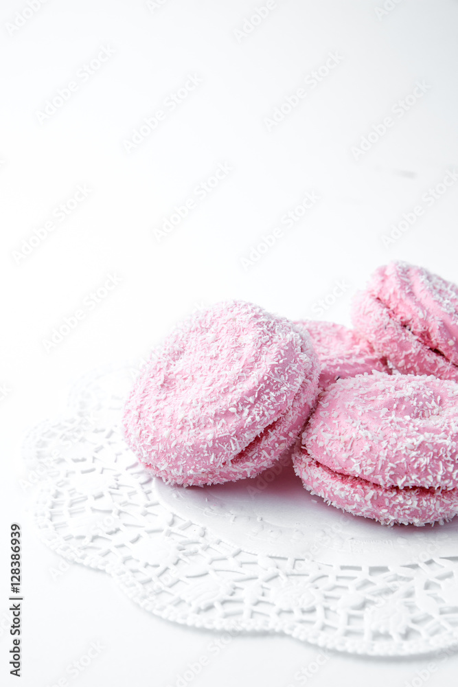 Fototapeta premium marshmallow - zephyr with coconut flakes on a white background.