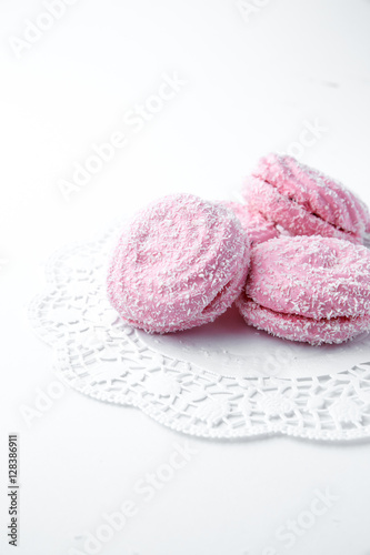 marshmallow - zephyr with coconut flakes on a white background.
