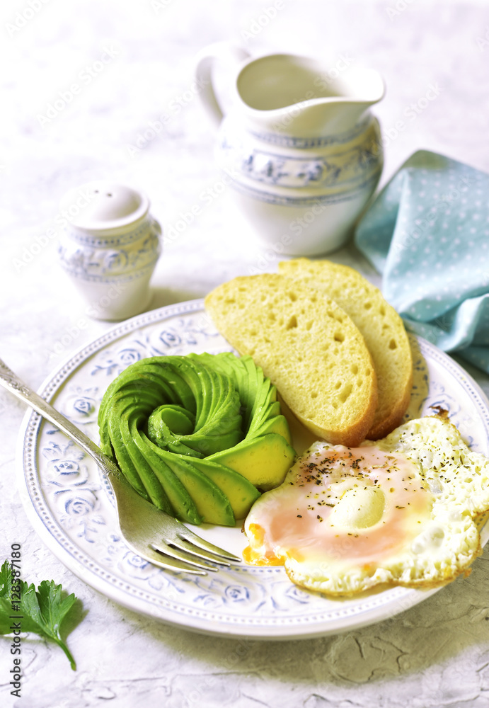 Fried egg and avocado.Healthy breakfast. Stock Photo | Adobe Stock